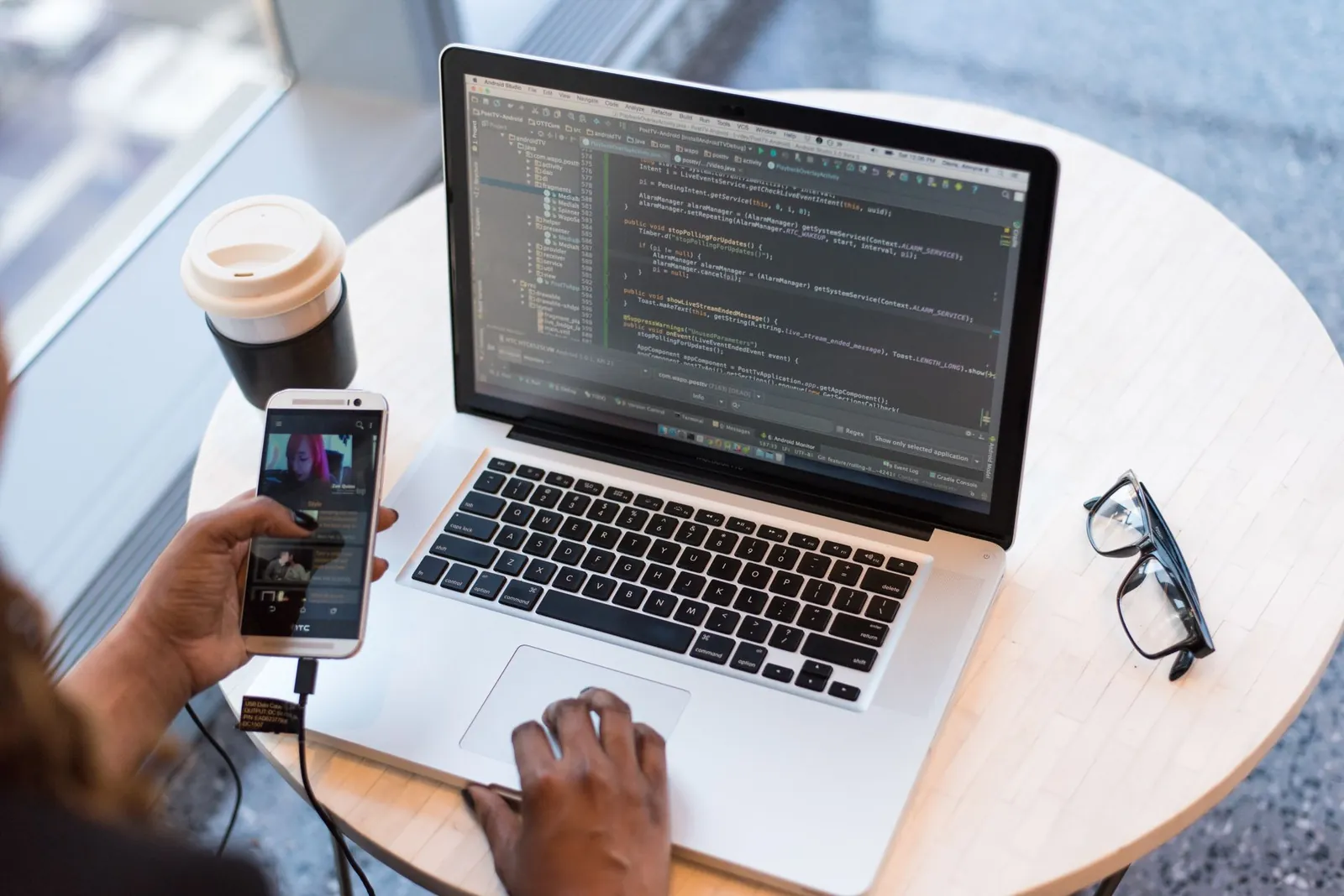 A student prototyping a game on a laptop at a workspace